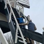 De molenaar begeleid kleine bezoekers op de trap nr. 20230839 A 